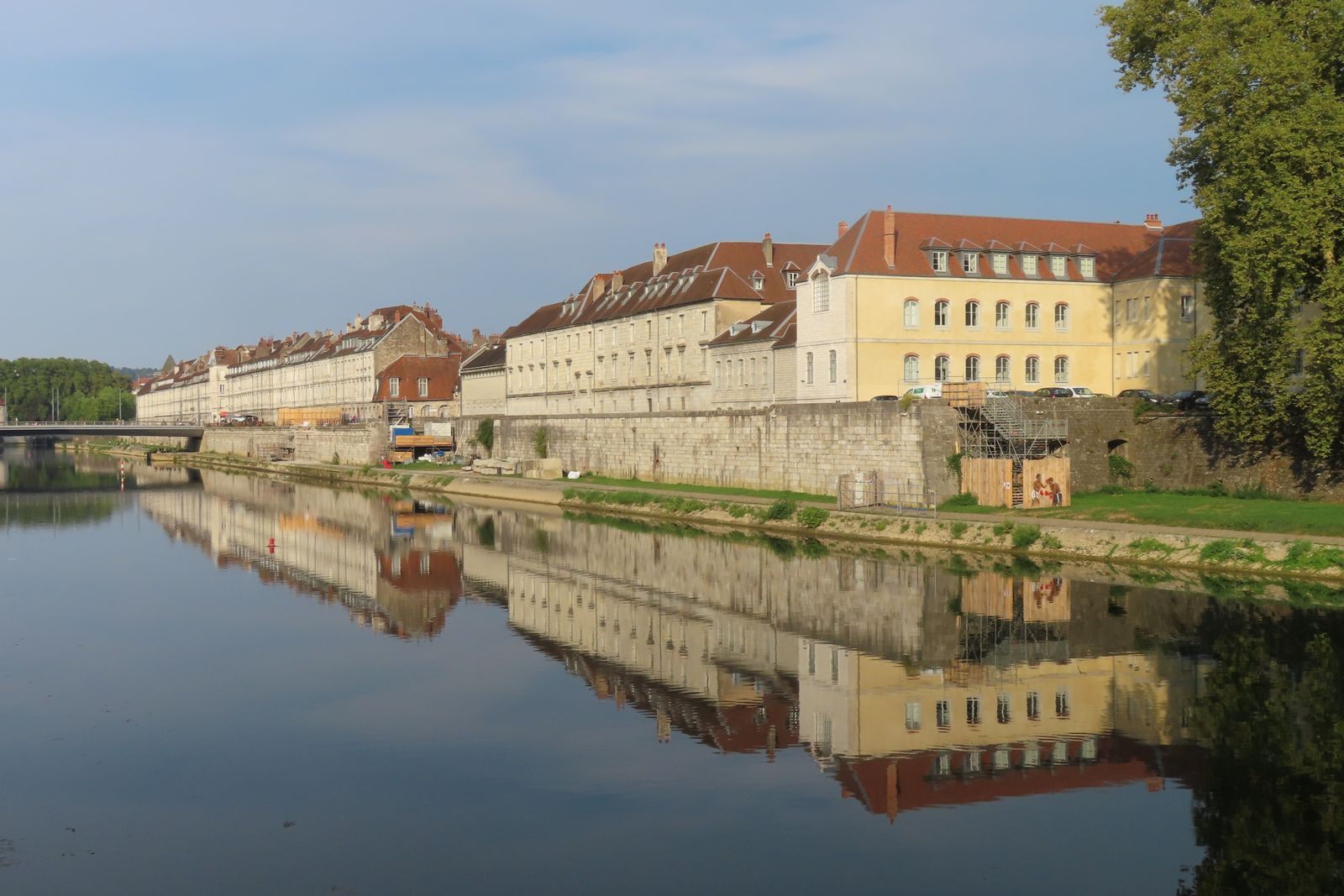 Historic French riverside buildings reflected in still water